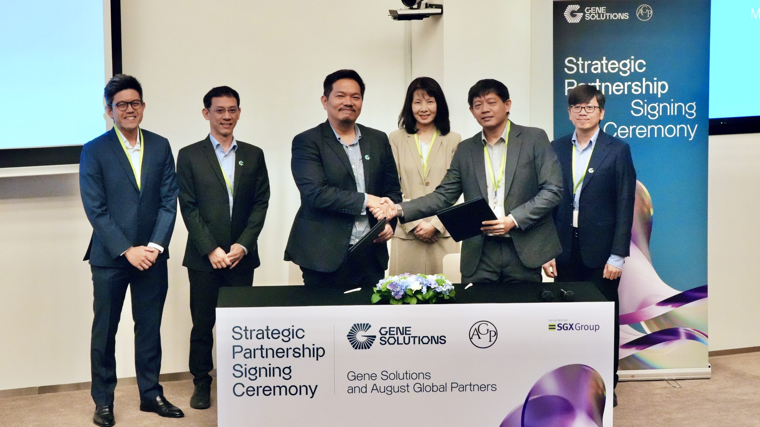 Dr. Nguyen Hoai Nghia of Gene Solutions and Dr. Basil Lui of August Global Partners shaking hands during the signing ceremony of a partnership to advance personalized cancer care.Title: Gene Solutions and August Global Partners Partnership Signing Ceremony