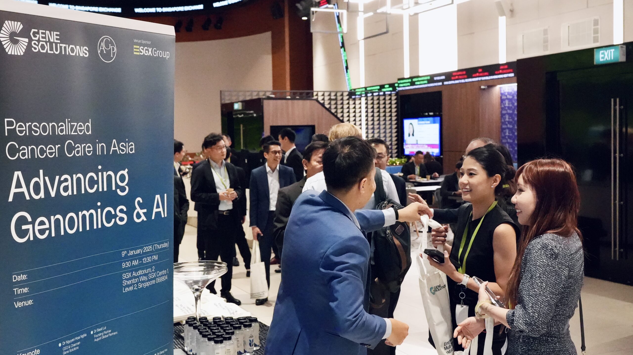 Attendees of the Gene Solutions and August Global Partners event interacting during a networking session on advancing genomics and AI in cancer care at SGX Auditorium.