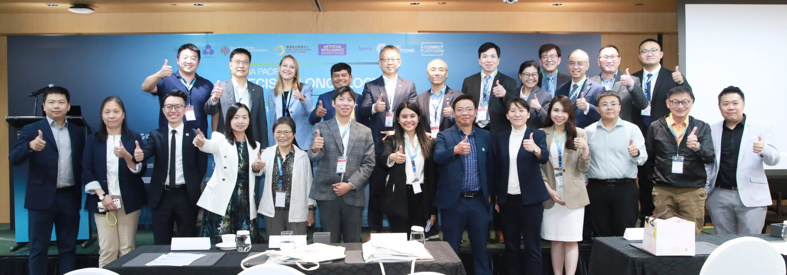 Group photo of speakers, moderators, and organizers at the APAC Precision Oncology Conference 2025 in Hong Kong, co-organized by the Hong Kong Precision Oncology Society, The Hong Kong Polytechnic University, the Artificial Intelligence Association of Hong Kong and partners including Gene Solutions and the K-CONNECT Platform.